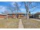 Charming single-story brick home featuring a welcoming walkway and a convenient carport for covered parking at 4040 S Inca St, Englewood, CO 80110