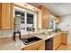 Bright kitchen featuring granite countertops, wooden cabinets, and a window over the sink at 4040 S Inca St, Englewood, CO 80110