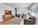 Inviting living room with a wood-burning stove, comfortable leather seating, and bright natural light at 4040 S Inca St, Englewood, CO 80110