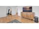 Bright and airy living room featuring hardwood floors, a modern cabinet, and a decorative mirror at 4040 S Inca St, Englewood, CO 80110