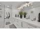 Modern bathroom with double vanity, quartz countertops, and glass enclosed shower at 3470 S Race St, Englewood, CO 80113