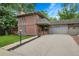 Charming brick home with well-manicured lawn, garage, and inviting front porch at 3470 S Race St, Englewood, CO 80113