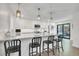 Well-lit modern kitchen with stainless steel appliances, a large island with bar seating, and white cabinets at 3470 S Race St, Englewood, CO 80113