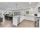 Spacious, modern kitchen flowing into the dining area, equipped with stainless appliances and white cabinets at 3470 S Race St, Englewood, CO 80113