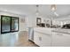 Bright kitchen features a farmhouse sink, stainless steel appliances and pendant lighting at 3470 S Race St, Englewood, CO 80113