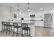 Modern kitchen with stainless steel appliances, a large island with bar seating, and white cabinets at 3470 S Race St, Englewood, CO 80113