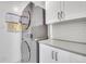 Well-organized laundry room with stackable washer/dryer and white subway tile backsplash at 3470 S Race St, Englewood, CO 80113