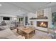 Inviting living room with a cozy fireplace, comfortable seating, a wooden coffee table, and an area rug at 3470 S Race St, Englewood, CO 80113