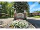 Kent Village neighborhood sign surrounded by colorful flower beds and lush greenery at 3470 S Race St, Englewood, CO 80113