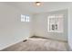 Cozy bedroom with neutral carpeting and a pair of bright windows at 24716 E Evans Dr, Aurora, CO 80018