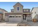 Charming two-story home with a stone-accented facade and attached two car garage at 24716 E Evans Dr, Aurora, CO 80018