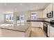 Modern kitchen featuring stainless steel appliances, light cabinets, and a large center island at 24716 E Evans Dr, Aurora, CO 80018