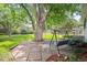 Secluded backyard featuring a swing, patio, and mature trees on a well-manicured lawn at 3225 S Race St, Englewood, CO 80113