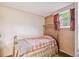 Bedroom with brass bed frame, vintage wallpaper and carpeting at 3225 S Race St, Englewood, CO 80113