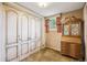 Bedroom features large closet doors, a window with curtains, and vintage furniture at 3225 S Race St, Englewood, CO 80113