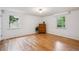 Bright bedroom with hardwood floors, white walls with trim, and natural light from two windows at 3225 S Race St, Englewood, CO 80113