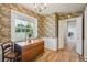 Cozy dining area featuring floral wallpaper, hardwood floors and abundant natural light at 3225 S Race St, Englewood, CO 80113