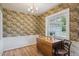 Charming dining room with vintage wallpaper, hardwood floors, and natural light at 3225 S Race St, Englewood, CO 80113