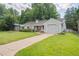 Traditional home with an attached garage, well-kept lawn and mature trees at 3225 S Race St, Englewood, CO 80113