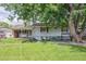 Charming home featuring well-manicured lawn, mature tree, and inviting front porch at 3225 S Race St, Englewood, CO 80113