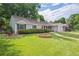 Charming single-story home featuring well-maintained lawn, lush landscaping and a welcoming curb appeal at 3225 S Race St, Englewood, CO 80113