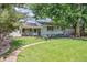 Charming home with a well-manicured lawn, large tree, and inviting front porch at 3225 S Race St, Englewood, CO 80113