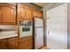 A view of the kitchen showcasing wood cabinetry and stainless steel refrigerator at 3225 S Race St, Englewood, CO 80113