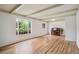 Bright living room with hardwood floors, large windows, and striking beamed ceilings at 3225 S Race St, Englewood, CO 80113