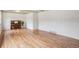 Sunlit living room with hardwood floors, a beamed ceiling, and a classic piano at 3225 S Race St, Englewood, CO 80113