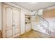 Entryway featuring built in bookcase, staircase and vintage wood-paneled doors at 3225 S Race St, Englewood, CO 80113