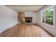 Inviting living room featuring hardwood floors, a cozy fireplace and large windows for ample natural light at 3225 S Race St, Englewood, CO 80113