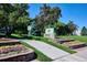Welcoming entrance to Romans Park featuring brick planters with colorful flowers at 3225 S Race St, Englewood, CO 80113