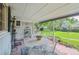Back patio with stone floor, outdoor seating, and large, well-maintained backyard at 3225 S Race St, Englewood, CO 80113