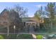 Charming exterior view of yellow and green house with dark iron gate and landscaping at 2614 Curtis St, Denver, CO 80205