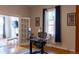 Functional home office with a desk, window with dark curtains, and ample lighting at 2614 Curtis St, Denver, CO 80205