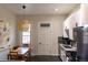 Eat in kitchen featuring white cabinets and a dining table under a decorative hanging light at 2614 Curtis St, Denver, CO 80205