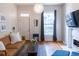 Inviting living room with hardwood floors, large window, and comfortable seating at 2614 Curtis St, Denver, CO 80205