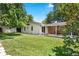 Spacious backyard with a green lawn, mature trees, and a covered patio, offering a great outdoor space at 1373 S Cape Way, Lakewood, CO 80232