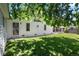 Well-maintained backyard featuring lush lawn, mature trees, and a covered patio area for outdoor enjoyment at 1373 S Cape Way, Lakewood, CO 80232