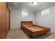 Cozy basement bedroom with vintage bed frame, small windows, and closet for storage at 1373 S Cape Way, Lakewood, CO 80232