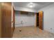 Unfinished basement area with open shelving, and essential utility connections at 1373 S Cape Way, Lakewood, CO 80232