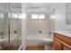 Bathroom features a bathtub with shower, mirror, and vanity area with wooden cabinets at 1373 S Cape Way, Lakewood, CO 80232