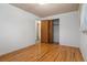 Neutral bedroom features hardwood floors, closet and access to hallway at 1373 S Cape Way, Lakewood, CO 80232