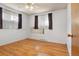 Light filled bedroom with hardwood floors and windows covered with curtains at 1373 S Cape Way, Lakewood, CO 80232