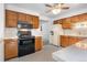 Well-equipped kitchen featuring tiled countertops, wood cabinetry, and modern appliances at 1373 S Cape Way, Lakewood, CO 80232