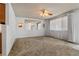 Neutral living room featuring carpet, a ceiling fan and windows to provide natural light at 1373 S Cape Way, Lakewood, CO 80232