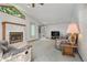 Inviting living room showcasing a cozy fireplace, large windows, and comfortable seating at 1373 S Cape Way, Lakewood, CO 80232