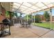 Covered patio with dining set and grill, perfect for entertaining or enjoying outdoor meals at 1373 S Cape Way, Lakewood, CO 80232