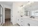 Elegant bathroom with double vanity and a walk-in shower at 692 Apex Rise St, Erie, CO 80516