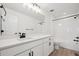 Modern bathroom with white cabinets and a soaking tub at 692 Apex Rise St, Erie, CO 80516